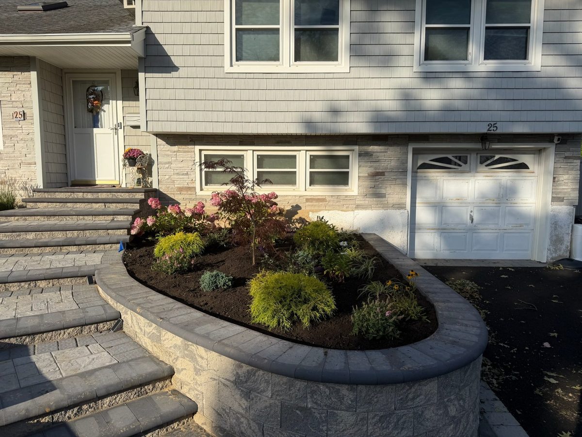 Same planter finished with Japanese maple, shrubs and fresh mulch