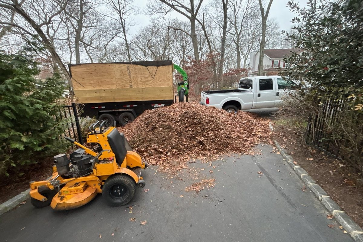 Fall leaf cleanup with mower and leaf truck in Suffolk County NY