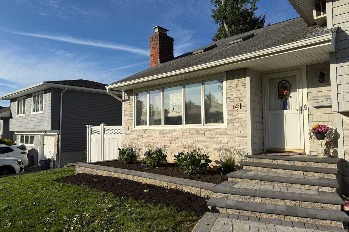 Paver walkway and stone planter wall at a Huntington NY home