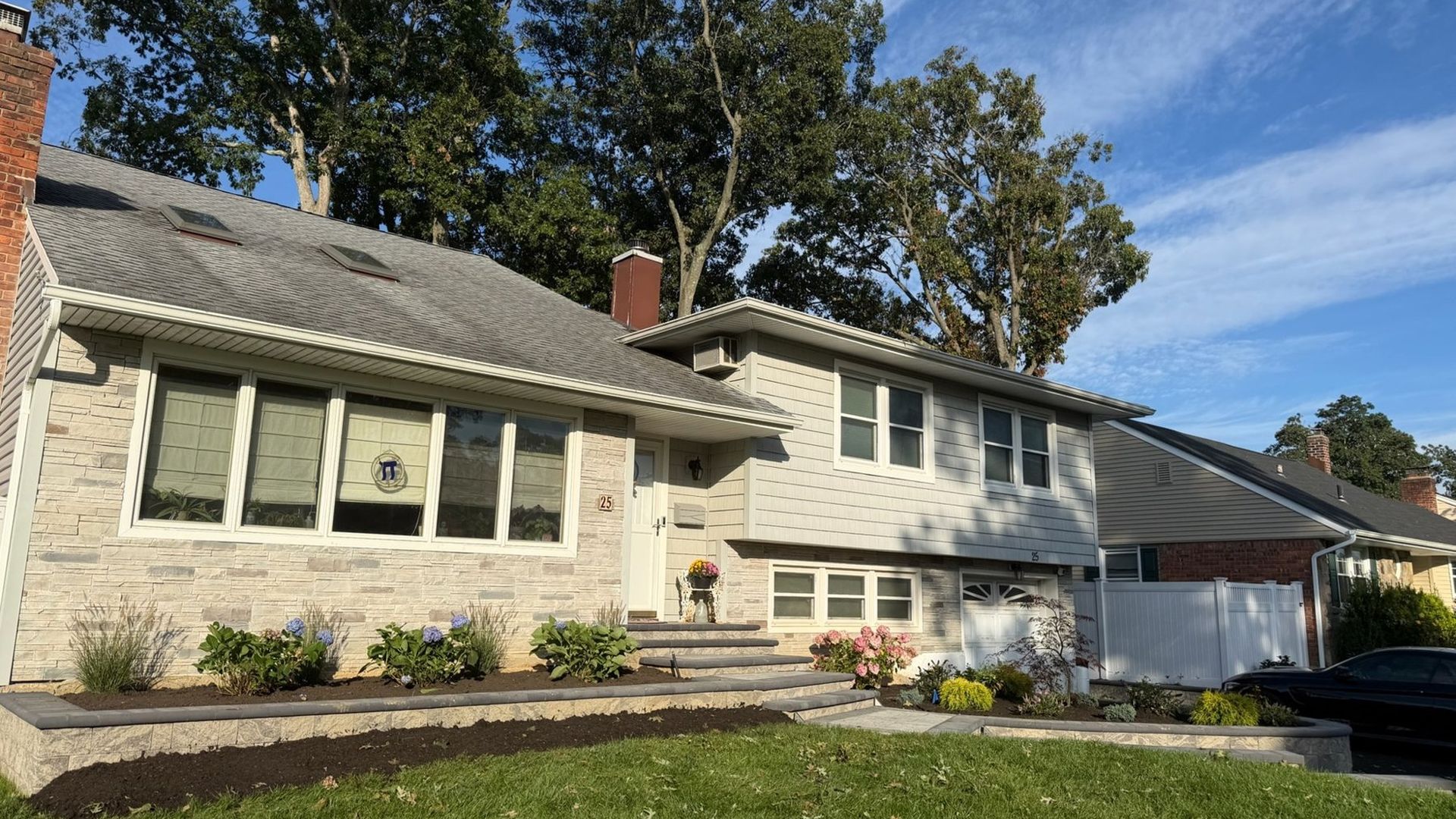 Paver walkway and stone planter wall at a Long Island home